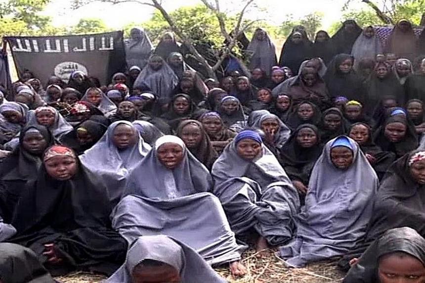 A screengrab taken on May 12, 2014, from a video of Nigerian Islamist extremist group Boko Haram obtained by AFP shows girls, wearing the full-length hijab and praying in an undisclosed rural location.&nbsp;Boko Haram released a new video claiming to