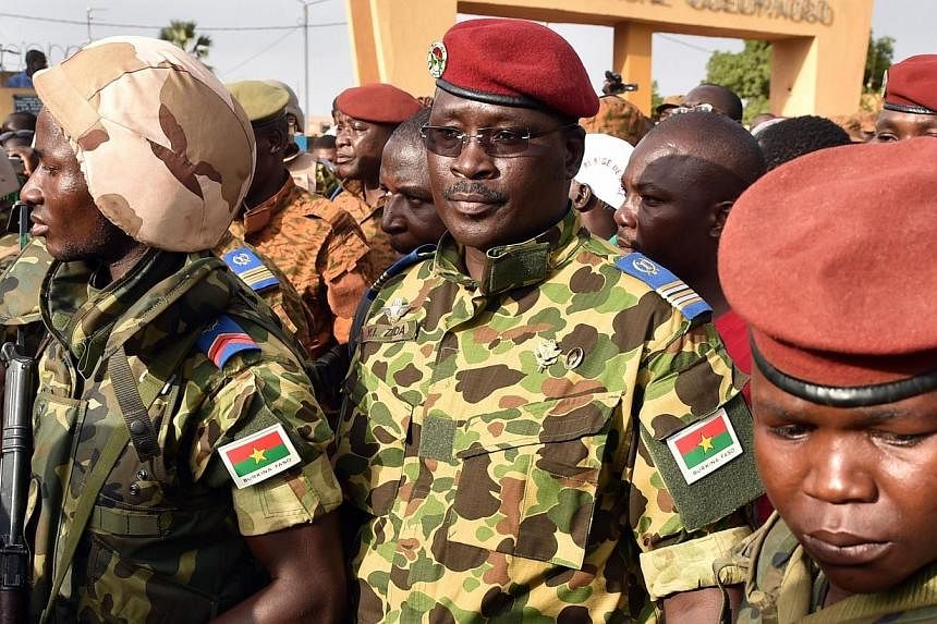 Burkina Faso's army on Saturday backed Lieutenant-Colonel Isaac Zida (centre) to lead a transition period after the ousting of president Blaise Compoare. -- PHOTO: AFP&nbsp;