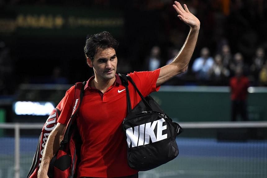 Switzerland's Roger Federer waves after his defeat against Canada's Milos Raonic during a quarter-final match at the ATP World Tour Masters 1000 indoor tennis tournament on Oct 31, 2014 at the Bercy Palais-Omnisport in Paris. -- PHOTO: AFP&nbsp;
