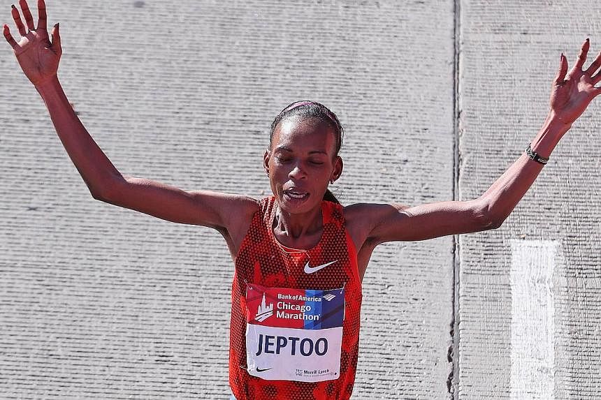Rita Jeptoo of Kenya celebrates after winning of the Chicago Marathon on Oct 12, 2014. Jeptoo, winner of the Boston and Chicago Marathons for the last two years, has failed an out-of-competition doping test, Athletics Kenya said on Friday. -- PHOTO:&