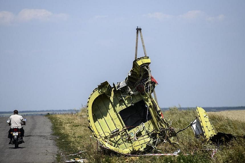 An Aug 2, 2014 file photo shows a man riding his motorbike at the crash site of the Malaysia Airlines Flight MH17 in the village of Hrabove (Grabovo), some 80km east of Donetsk. Dutch investigators gathered new human remains at the site of the crash 
