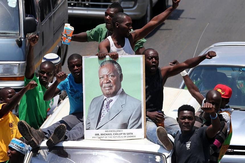 Patriotic Front cadres escort President Michael Sata's body to Mulungushi International Conference Centre on Nov 1, 2014 in Lusaka.&nbsp;Hundreds of people lined Lusaka's Great East road on Saturday as the body of Zambian president Michael Sata, who 