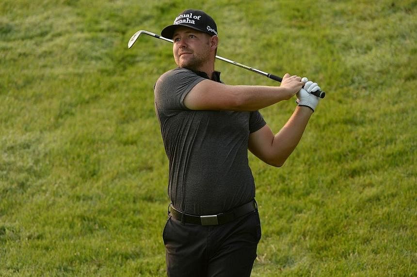 American Ryan Moore won the CIMB Classic at the Kuala Lumpur Golf and Country Club on Sunday, successfully defending the title he won last year. -- PHOTO: AFP