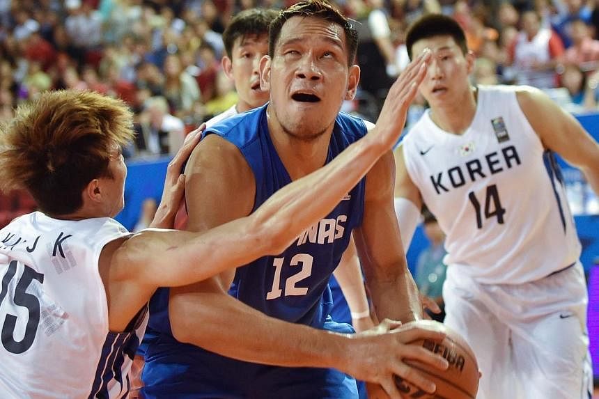 June Mar Fajardo of the Philippines (centre) competes with Kim Jong-Kyu of South Korea (left) during their men's quarter-final group H basketball match at Samsan World Gymnasium Ground during the 17th Asian Games in Incheon on Sept 27, 2014.&nbsp;The