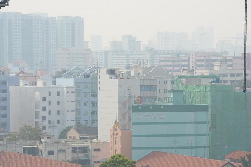 The haze in Geylang on Sunday.&nbsp;The three-hour Pollutant Standards Index (PSI) inched upwards into the unhealthy range on Sunday afternoon, hitting 104 at 3pm. -- ST PHOTO: AZIZ HUSSIN&nbsp;