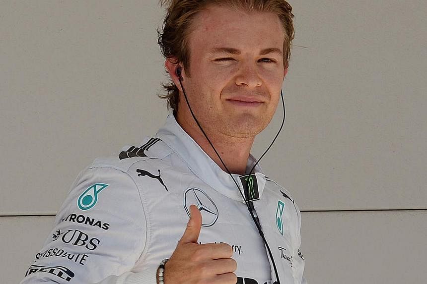 Mercedes AMG Petronas driver Nico Rosberg of Germany celebrates after qualifying for the pole position for the United States Formula One Grand Prix at the Circuit of The Americas in Austin, Texas on Nov 1, 2014. -- PHOTO: AFP