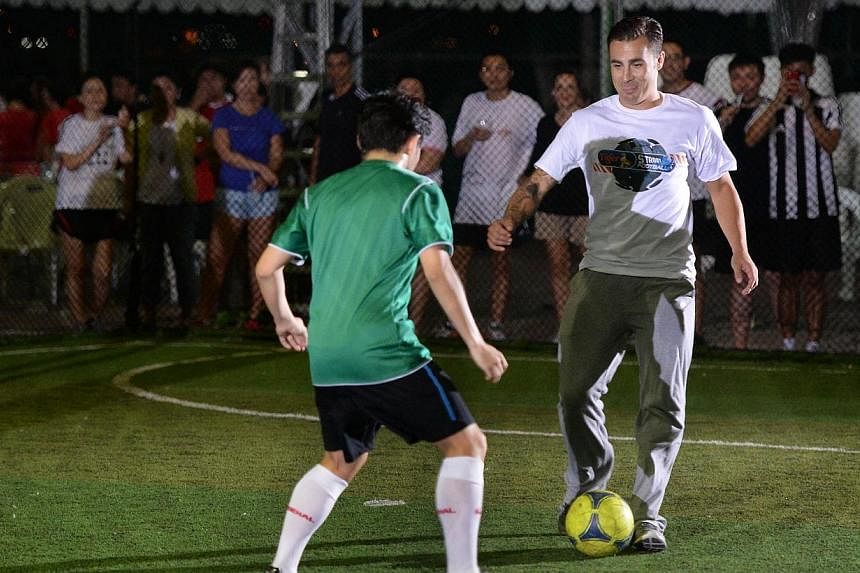 Italy's World Cup-winning captain Fabio Cannavaro, seen here during a visit to Singapore last year, has been tipped to replace his former national coach Marcello Lippi as boss of Guangzhou Evergrande.&nbsp;-- PHOTO: ST FILE