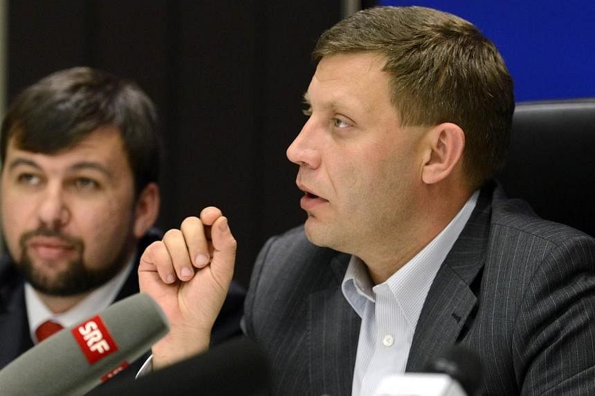 Alexander Zakharchenko (right), Prime Minister of the self-proclaimed Donetsk People's Republic and presidential candidate, speaks to media during a press conference in the eastern Ukrainian city of Donetsk on Nov 2, 2014. -- PHOTO: AFP
