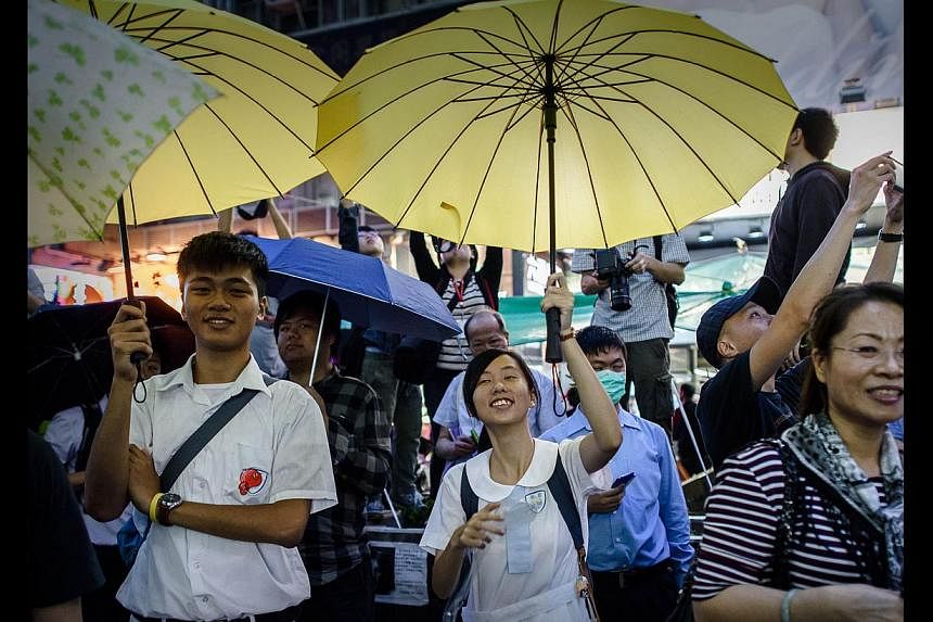 Occupy Central protesters opening their umbrellas to mark one month since they took to the streets last Tuesday in Mongkok. The members of the so-called Occupy Central Generation are drawn from the cohorts born during and since the 1980s, mostly stud
