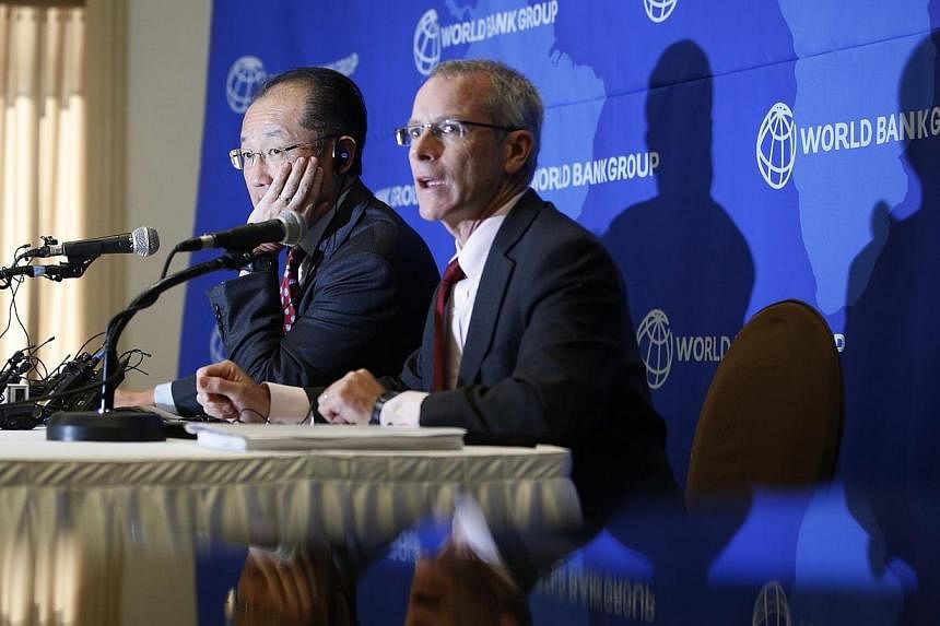 World Bank Group president Jim Yong Kim (left) listens to a reporter's question during a news conference in Seoul on Nov 4, 2014.&nbsp;Asian countries are not contributing enough to the global effort to fight Ebola, despite having a wealth of trained