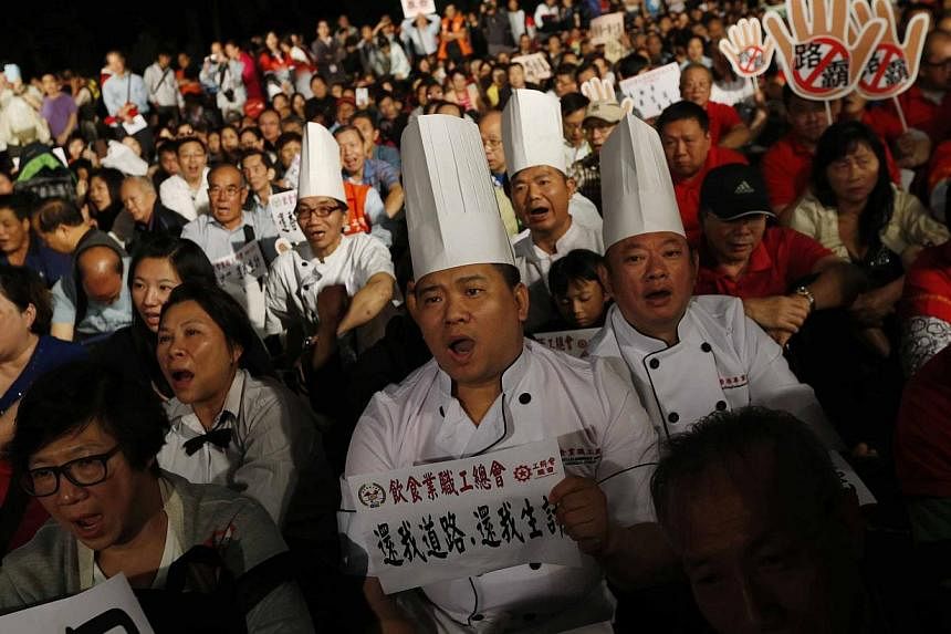 Chefs chant slogans as they take part in an anti-Occupy Central protest, against the civil disobedience movement which has been affecting their livelihood, in Hong Kong, on Nov 3, 2014. -- PHOTO: REUTERS&nbsp;