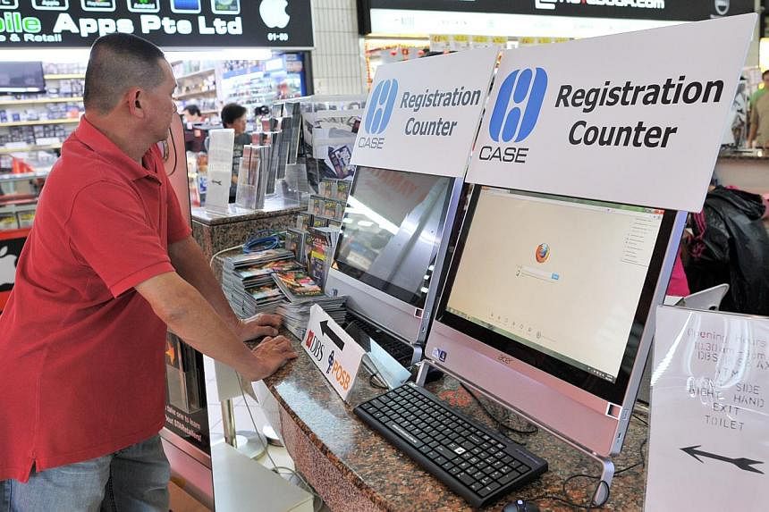 A man standing at the Consumers Association of Singapore (CASE) complaints kiosk for shoppers at Sim Lim Square. -- PHOTO: ST FILE