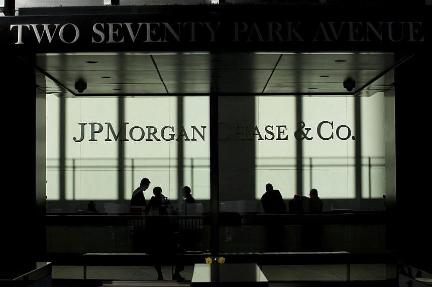 People walk inside JP Morgan headquarters in New York, in this file photo from Oct 25, 2013. -- PHOTO: REUTERS
