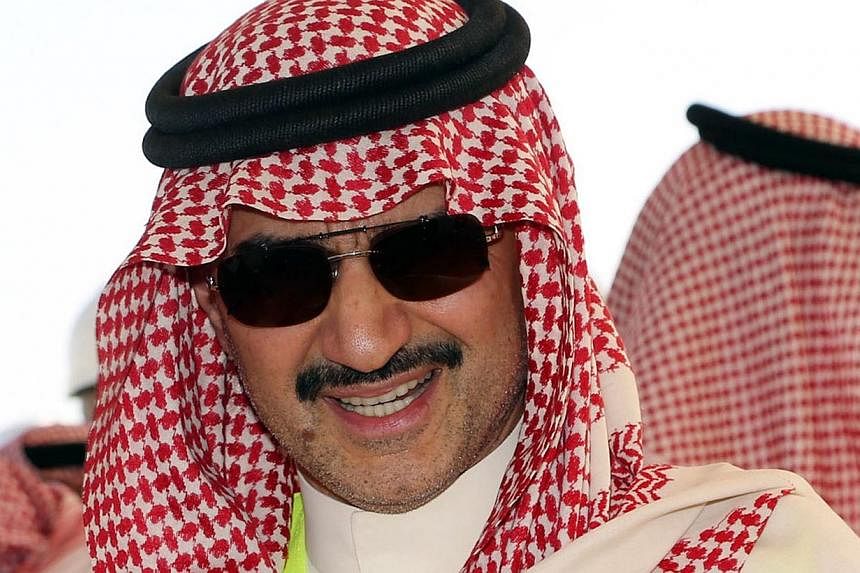 Saudi billionaire owner of Kingdom Holding Company, Prince Alwaleed Bin Talal, speaks to the media during a press conference at the location of the Kingdom Tower and the Kingdom City in Obhor, 30km north of Jeddah City, on Nov 4, 2014. The fall of cr