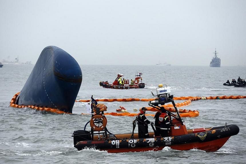 Rescue boats sail around the South Korean passenger ship Sewol which sank, during their rescue operation in the sea off Jindo, April 17, 2014.&nbsp;The son of the South Korean tycoon blamed for the Sewol disaster was sentenced to three years in priso