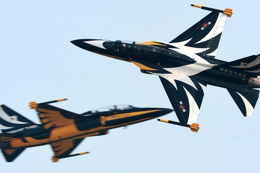 South Korea’s Black Eagles aerobatic team flying T-50s fighter jets.&nbsp;South Korea on Wednesday scrapped its plan to send a pair of T-50s to a Chinese airshow next week, citing pressure from the United States. -- PHOTO:&nbsp;REPUBLIC OF KOREA AI