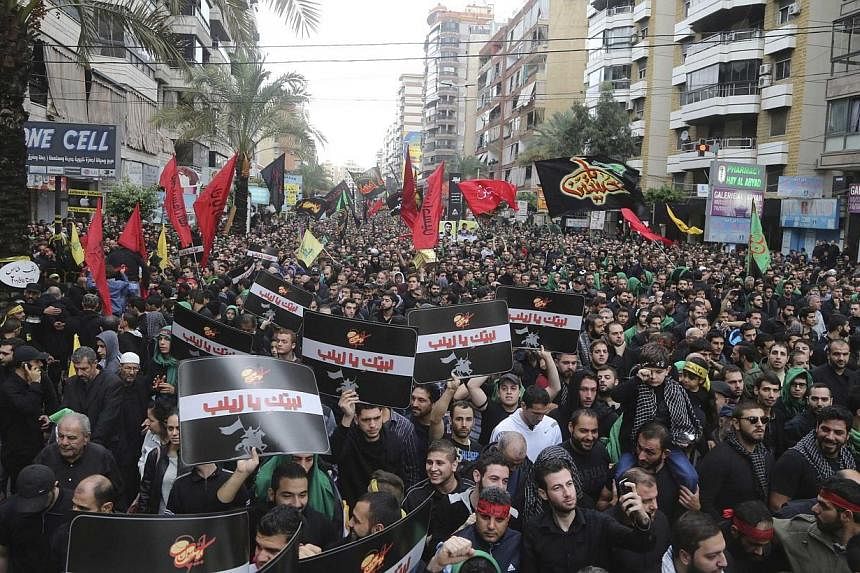 Lebanese Hezbollah supporters march during a religious procession to mark Ashoura in Beirut's suburbs on Nov 4, 2014.&nbsp;The head of Al-Qaeda's Syrian affiliate, Al-Nusra Front, has threatened neighbouring Lebanon in a new audio message warning tha