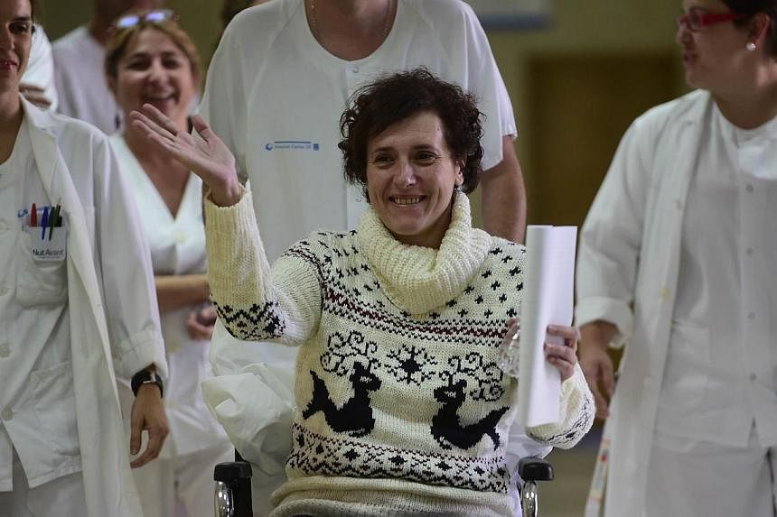 Former ebola patient Spanish nurse Teresa Romero (centre) waves on arrival to a press conference at Carlos III Hospital in Madrid on Nov 5, 2014, following her recovery from the deadly virus.&nbsp;A Spanish nurse who was the first person to catch Ebo