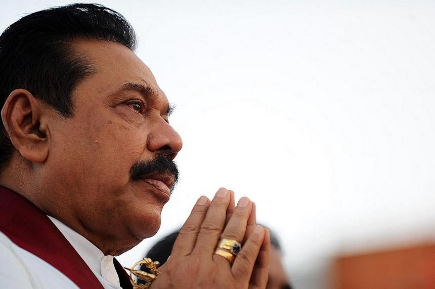 Sri Lanka President Mahinda Rajapakse praying during a religious ceremony at a 76 million dollar oil tank farm at the southern deep sea port of Hambantota&nbsp;on June 22, 2014.&nbsp;Sri Lanka's president has asked the top court to rule on whether he