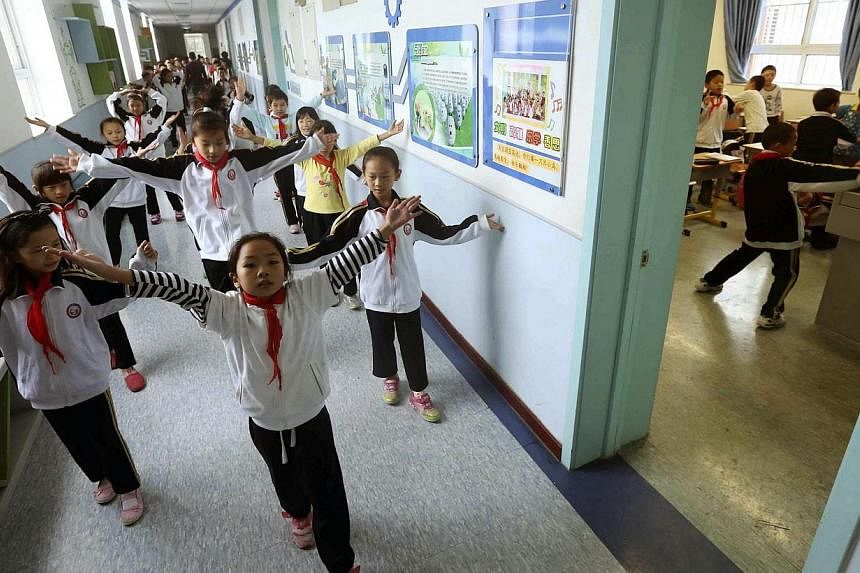 China's Communist Party will introduce socialist values including "freedom" and "democracy" into the classroom via songs and poetry, state media said Wednesday, as the party strives to maintain its legitimacy. -- PHOTO: REUTERS
