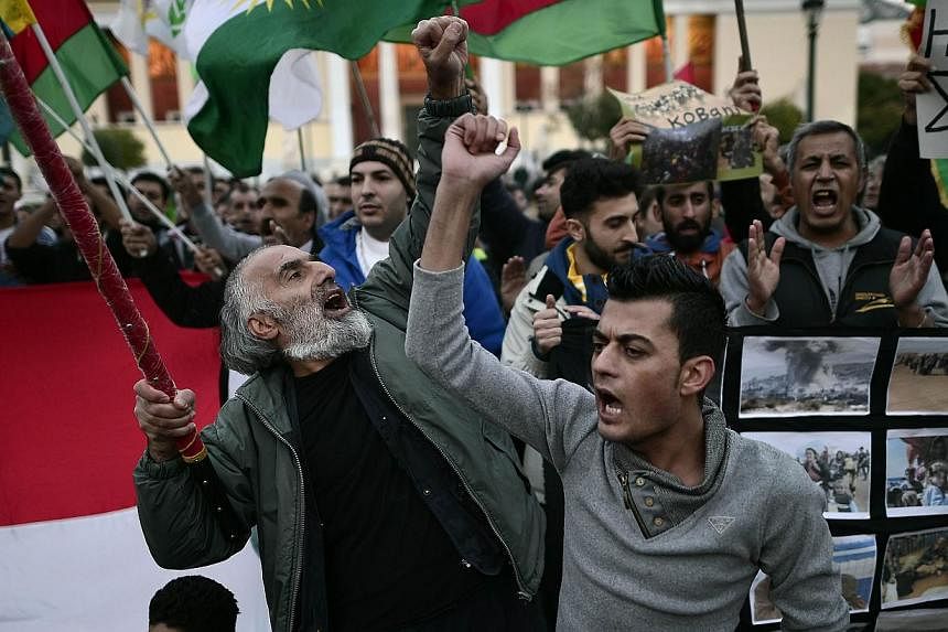 Kurds demonstrating in Athens on Saturday. Recent media reports suggest that citizens of Greece and Turkey have joined the YPG. -- PHOTO: AFP