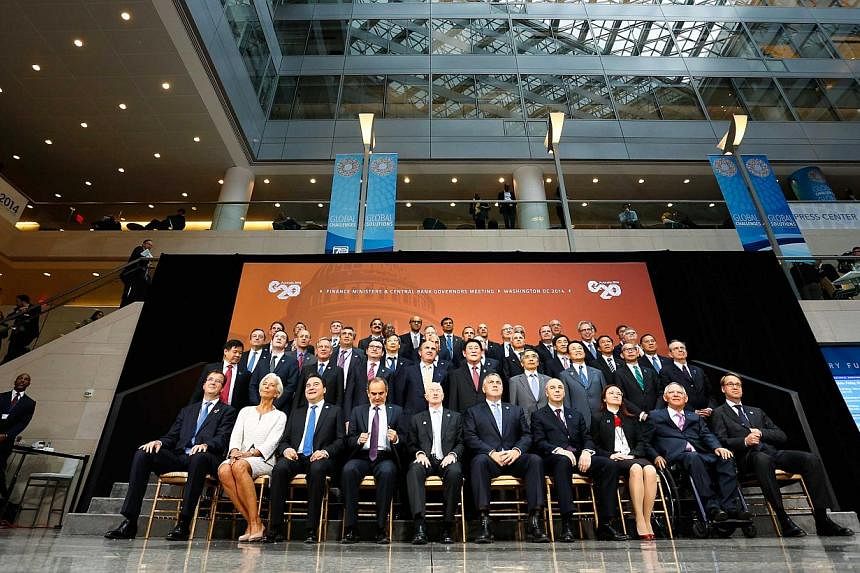 G-20 finance ministers and central bank governors gather for a family photo after their meeting during the IMF-World Bank annual meetings in Washington on Oct 10, 2014. -- PHOTO: REUTERS