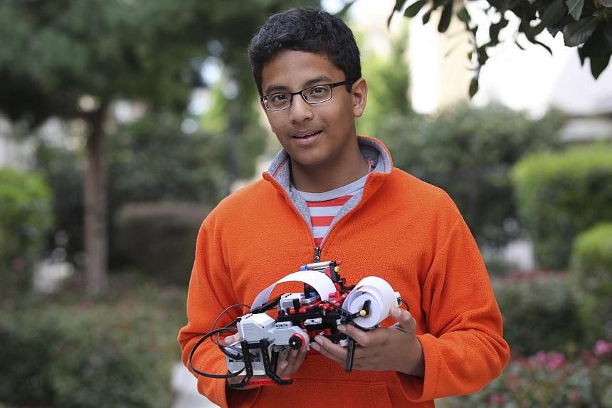 Shubham Banerjee, founder of Braigo Labs, holds a printer in Palo Alto, California, in this 2014 handout photo provided by Braigo Labs.&nbsp;Banerjee was 12 years old when he closed an early-stage funding round with Intel Capital, the company's ventu