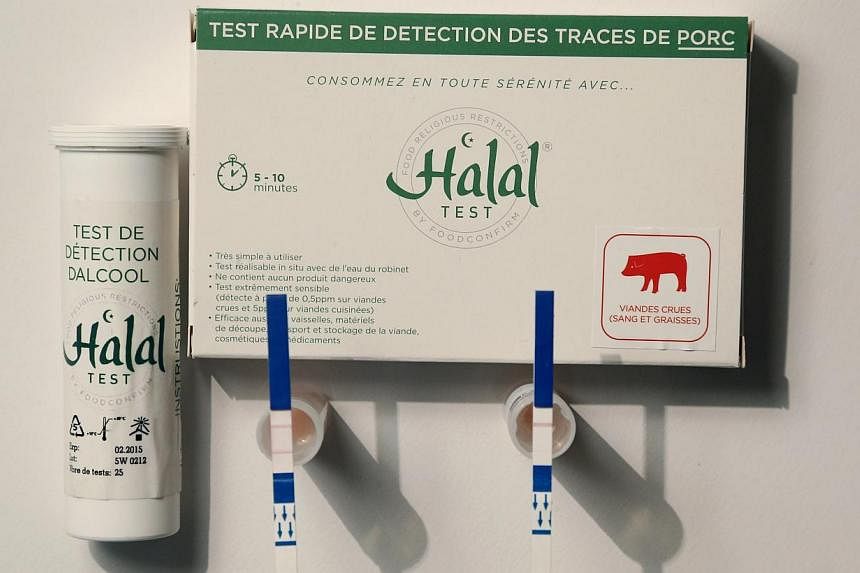 An illustration picture shows a kit to test for the presence of pork in food for use by Muslims, with small test tubes in which a food sample is mixed with warm water and test strips, at Capital Biotech's offices in Asnieres sur Seine on Oct 21, 2014