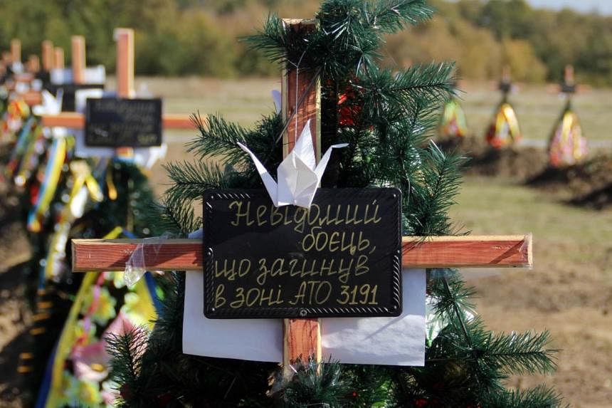 A picture taken on October 12, 2014, showing the Kushugumske cemetery in the suburbs of Zaporizhia, south-eastern Ukraine, where the remains of unidentified Ukrainian soldiers killed in fighting against pro-Russia separatists are buried. Before the w