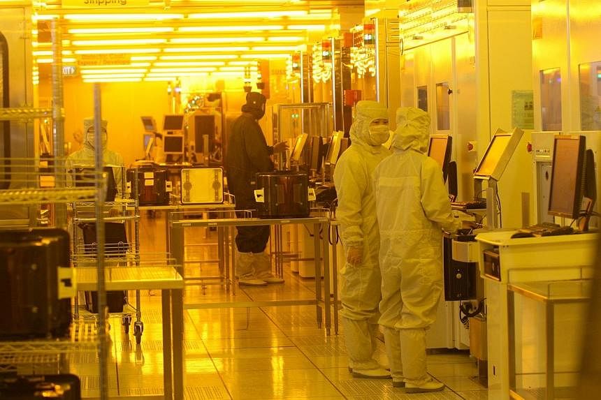 Employees at the production line at STATS ChipPAC, a mainboard-listed semiconductor chip packaging and testing firm.&nbsp;A Chinese company has made a takeover bid for local semiconductor firm STATS ChipPAC, the latter said on Thursday. -- PHOTO: ST 