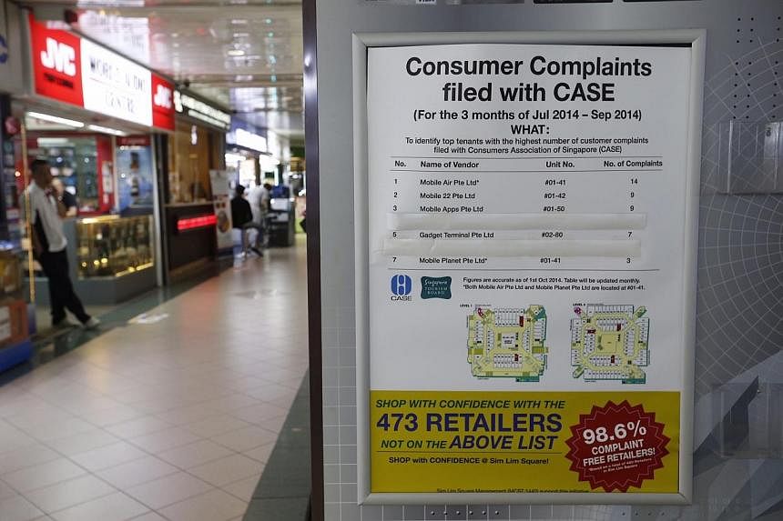 A notice on the second level listing names of shops that were complained against in Sim Lim Square on Nov 6, 2014.&nbsp;-- ST PHOTO: KEVIN LIM