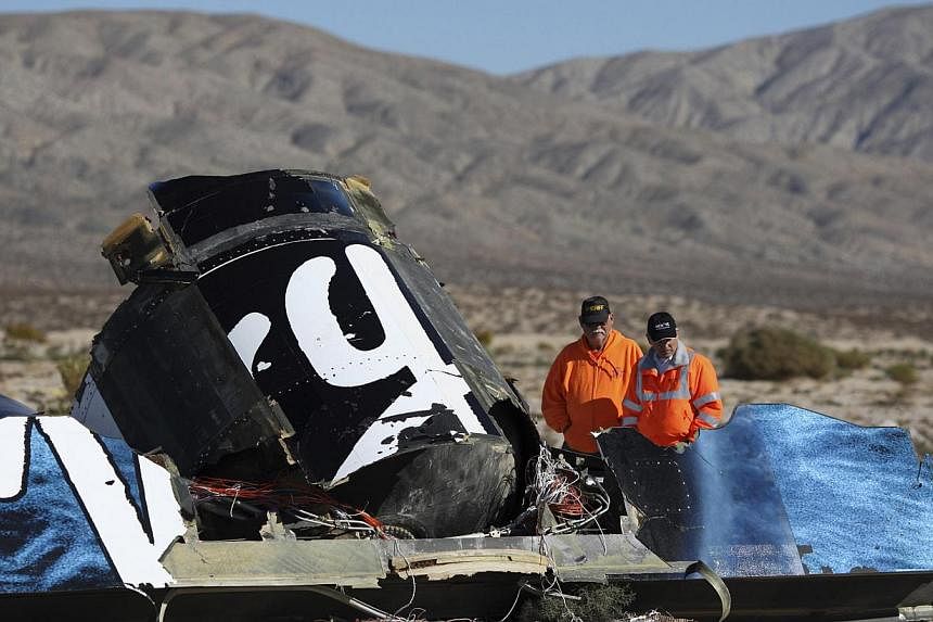 Sheriffs' deputies look at wreckage from the crash of Virgin Galactic's SpaceShipTwo near Cantil, California. -- PHOTO: REUTERS