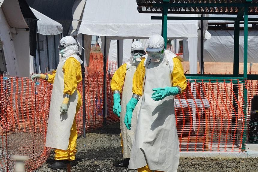 Health workers dressed in clothing to protect against Ebola at a clinic run by the non-governmental organisation Medecin Sans Frontieres - or Doctors Without Borders - in Monrovia on Nov 1, 2014.&nbsp;Doctors in Germany said on Wednesday a patient in