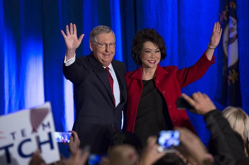Mitch McConnell (right) celebrates with his wife Elaine Chao at his election night event on Nov 4, 2014 in Louisville, Kentucky. -- PHOTO: AFP