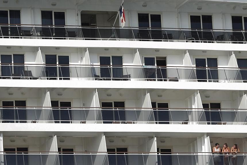Passengers look out of a cruise liner as it gets ready to depart from Istanbul. Aspiring militants have been travelling on cruise ships to reach conflict areas in the Middle East, Interpol has warned. The destination for many is Turkey, considered th