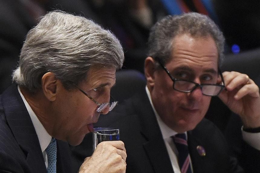 US Secretary of State John Kerry (left) has a drink as US Trade Representative Michael Froman (right) looks on at the start of Asia-Pacific Economic Cooperation (APEC) Summit ministerial meetings at the China National Convention Centre (CNCC) in Beij