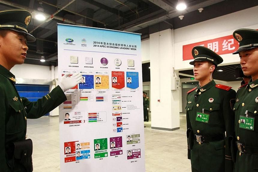 This picture taken on Nov 6, 2014 shows paramilitary soldiers learning about security checking rules in the China National Convention Center, where the Asia-Pacific Economic Cooperation (APEC) annual summit is being held in Beijing. Top leaders and m