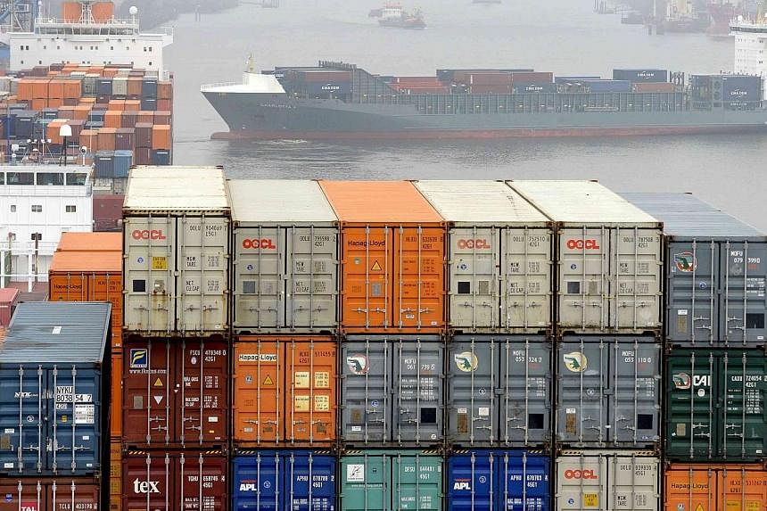 Containers are loaded at the container terminal Altenwerder in the harbour in Hamburg on Nov 18, 2013. -- PHOTO: REUTERS