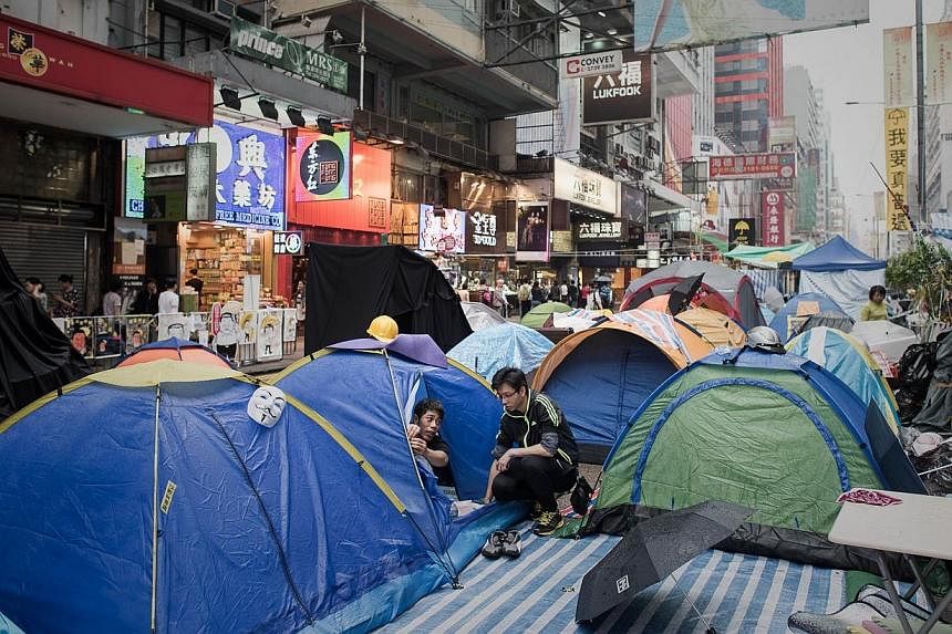 Pro-democracy protesters chat at a protest site in the Mongkok district of Hong Kong on Nov 7, 2014.&nbsp;Hong Kong protest leaders made a formal request Friday to speak with China over political reform, calling on a pro-Beijing politician to act as 