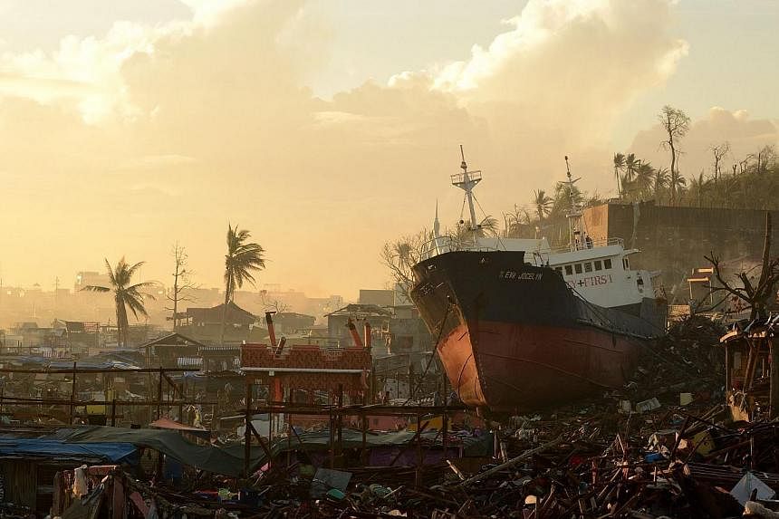 A ship is washed ashore crushing houses in Tacloban, Leyte Province, after Super Typhoon Haiyan swept over the central Philippines on Nov 25, 2013.&nbsp;Philippine President Benigno Aquino on Friday defended the pace of rebuilding in communities rava