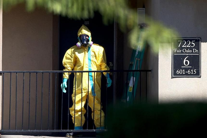 A hazmat team member arrives to clean a unit at the Ivy Apartments, where a confirmed Ebola virus patient was staying, on Oct 3, 2014 in the Texas city of Dallas.&nbsp;Texas is almost done watching for Ebola in people who had contact with either a Li