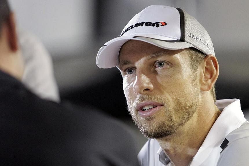 McLaren Formula One driver Jenson Button of Britain is interviewed outside his team hospitality suite at the paddock area of Singapore F1 Grand Prix in Singapore Sept 18, 2014.&nbsp;Button dropped a heavy hint on Thursday that he is prepared to walk 