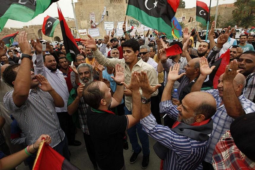 Libyans celebrate after the Supreme Court invalidated the country's parliament, at Martyrs' Square in Tripoli November 6, 2014. Libya's internationally recognised parliament on Thursday rejected a supreme court decision to nullify it, saying the ruli