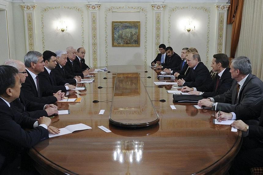 Russia's President Vladimir Putin (fourth right) attends a meeting with Parliament members of the Collective Security Treaty Organisation at the Novo-Ogaryovo state residence outside Moscow Nov 6, 2014. Putin held talks with top security chiefs on Th