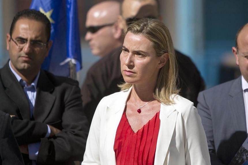 The European Union's new foreign affairs chief Federica Mogherini (centre) visits the UN-run Barhain boys school where displaced Palestinian families found refuge on Nov 8, 2014 in Gaza City.&nbsp;The top EU diplomat appealed on Saturday for the esta