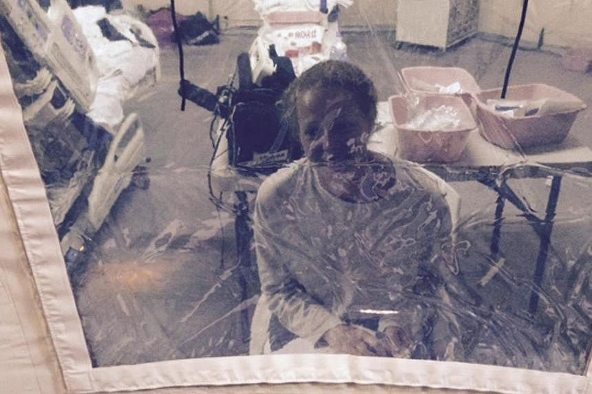Kaci Hickox, a nurse who arrived in New Jersey on Oct 24 after treating Ebola patients in West Africa, speaks to her lawyer Norman Siegel from a hospital quarantine tent in Newark, New Jersey, on Oct 26, 2014. -- PHOTO: REUTERS