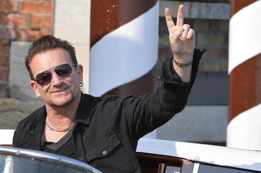 Irish rocker Bono has defended Spotify from criticism it pays too little to people who create music, saying digital music streaming services are opening up new ways for musicians to reach their public. -- PHOTO: AFP