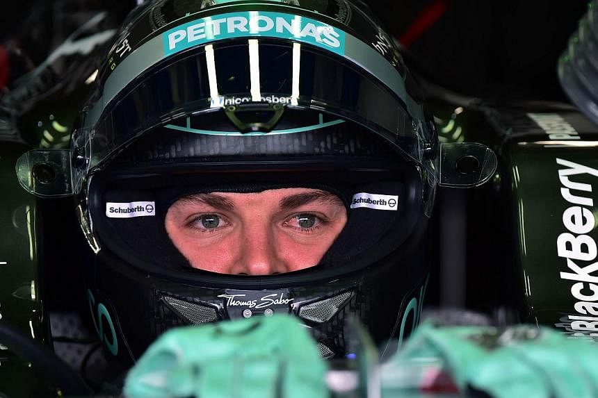 Mercedes' German driver Nico Rosberg awaits in his car at the Interlagos racetrack in Sao Paulo, Brazil on Nov 8, 2014, on the eve of the Brazil Formula One Grand Prix. -- PHOTO: AFP