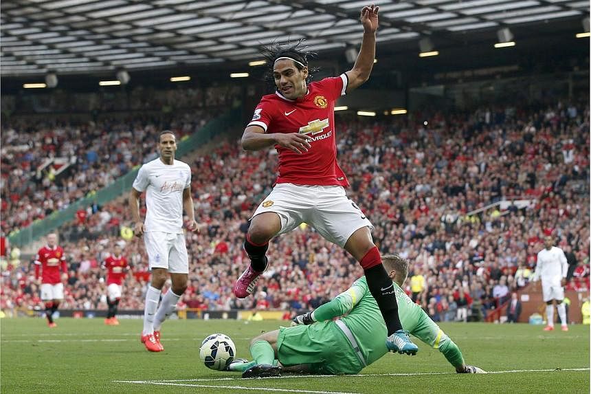 Whether it be injury or for reasons of balance, Manchester United manager Louis van Gaal has warned striker Radamel Falcao could face a lengthy absence from his top-heavy side as they struggle to find a winning formula. -- PHOTO: REUTERS