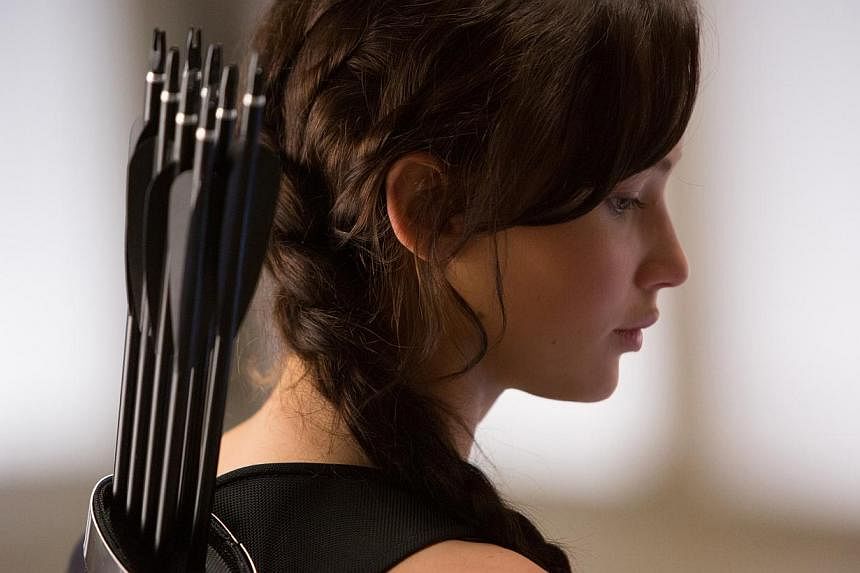 A cinema still from The Hunger Games: Catching Fire starring Jennifer Lawrence. The blockbuster post-apocalyptic action franchise The Hunger Games is hitting the stage and will open London in the summer of 2016 in a new purpose-built theatre next to 